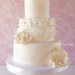 Ruffles and royal icing alencon lace with roses, peonies, and hydrangeas.